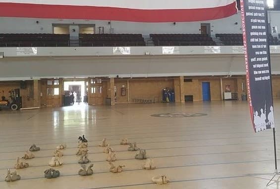 22 rucksacks laid out under the American flag — a tribute to the 22 veterans lost to suicide each day